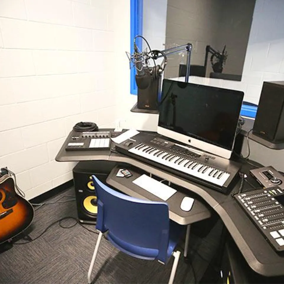 Desk with a keyboard, computer, and audio mixer to be used for teens ages 12-20 to be creative.